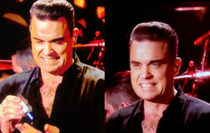 Robbie Williams se desinfecta la mano de saludar