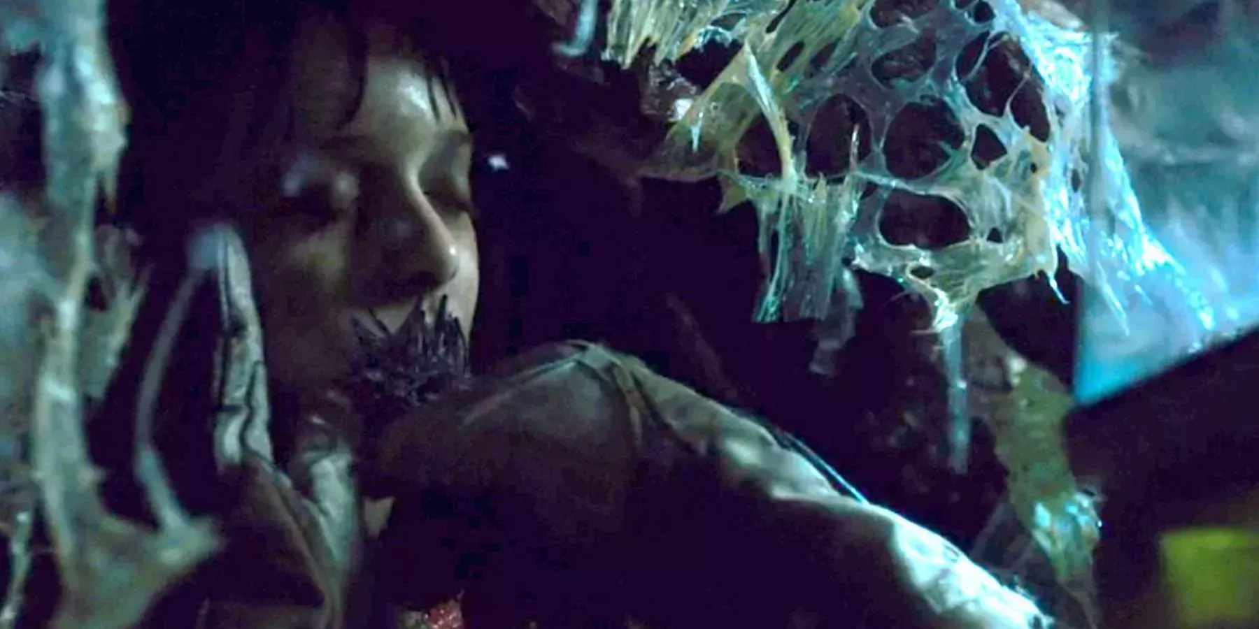 Will cocooned with the tube down his throat while a gloved hand tries to remove it - Stranger Things 1