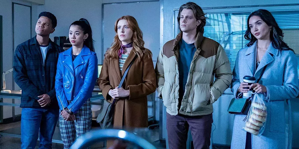 Nancy, Bess, Ace, George, and Nick wearing jackets and looking ahead 