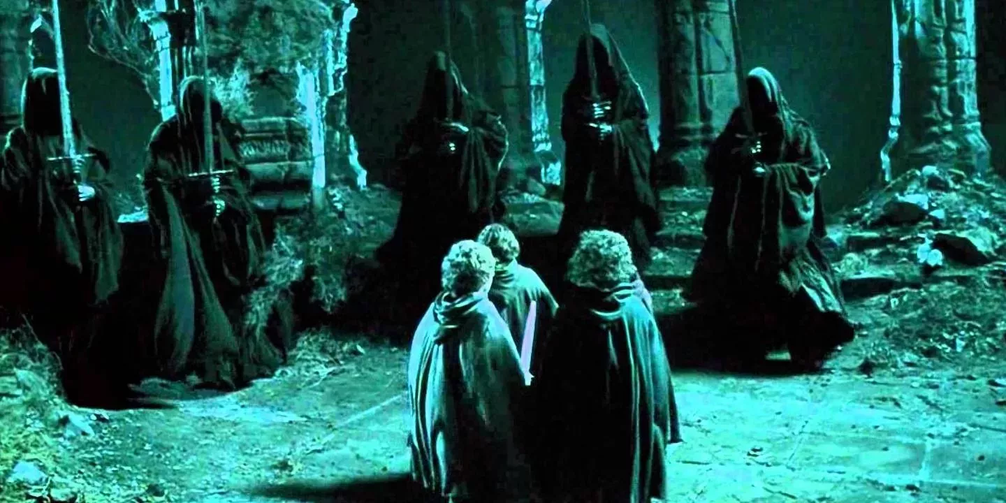 The Hobbits stand facing The Nazgul who are holding swords in The Lord of the Rings