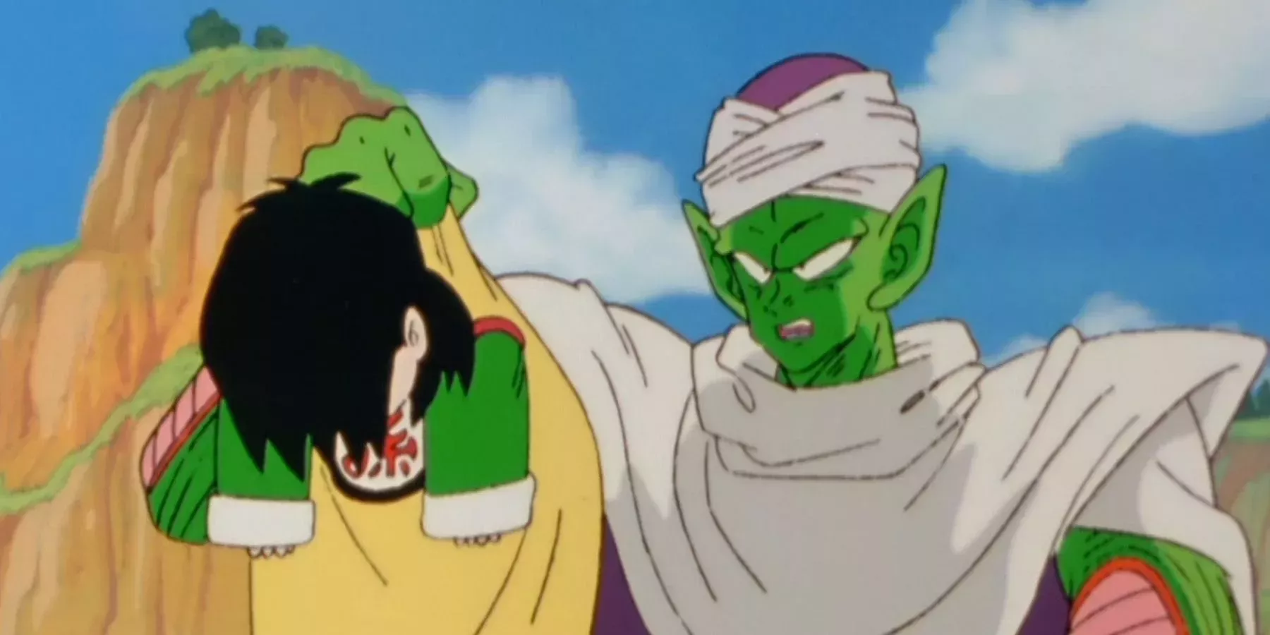 Piccolo holds up Gohan during training in Dragon Ball Z.