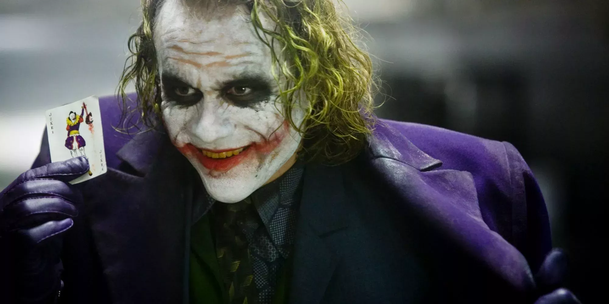 Joker holding up a card in The Dark Knight