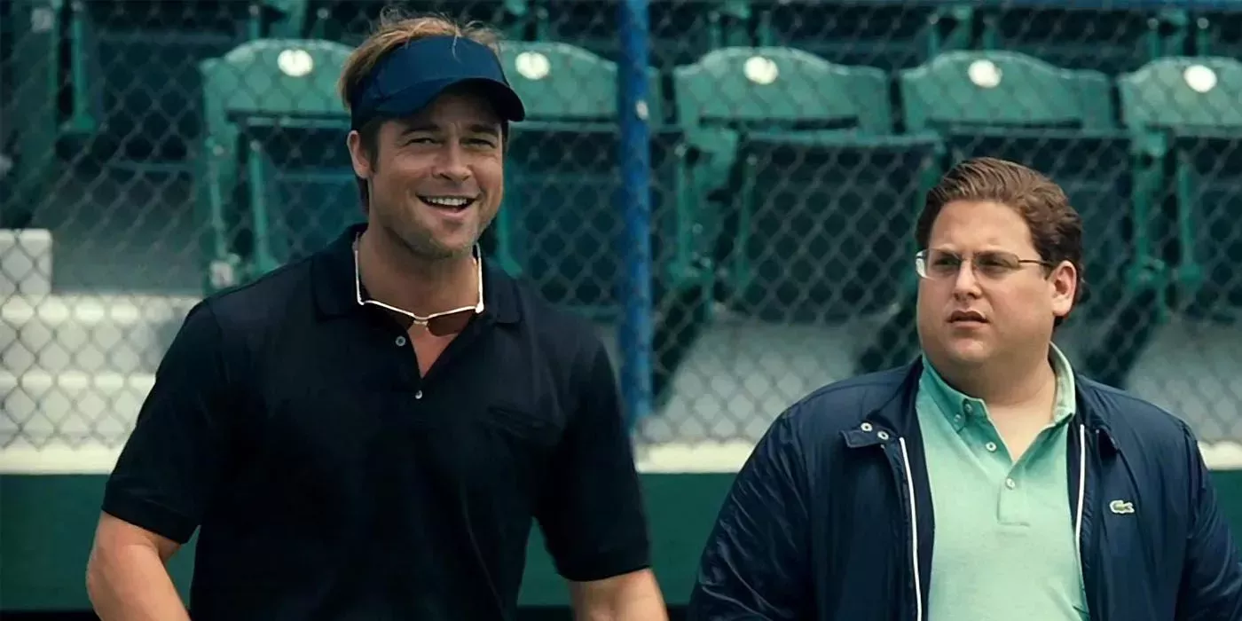 Brad Pitt and Jonah Hill watch the Oakland A's practice during the events of Moneyball (2011)