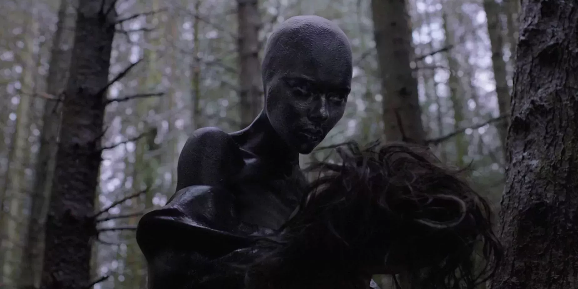 Alien holds her human shell at the end of Under The Skin Movie