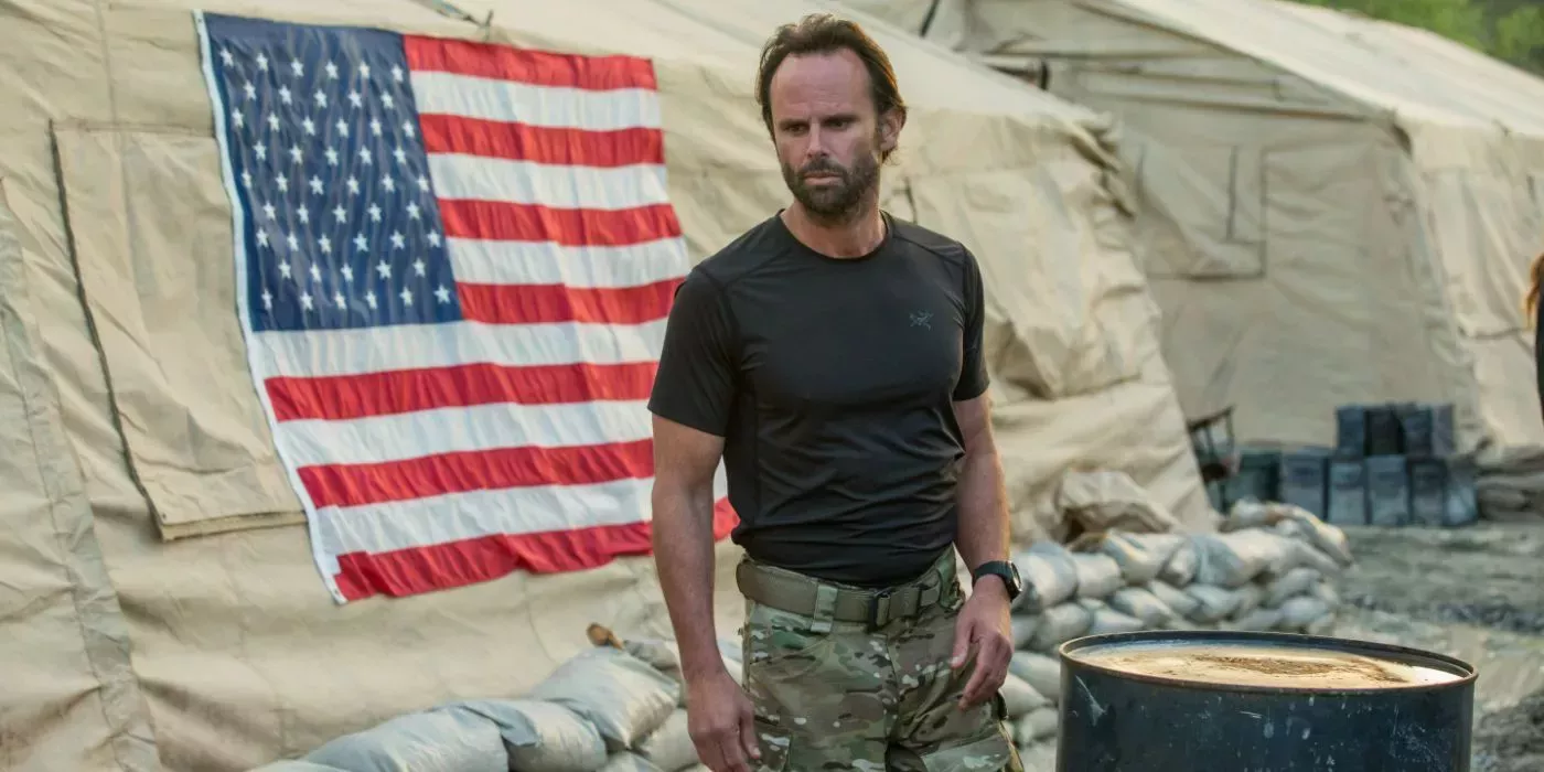 Rip (Walton Goggins) stands by an American military tent in SIX