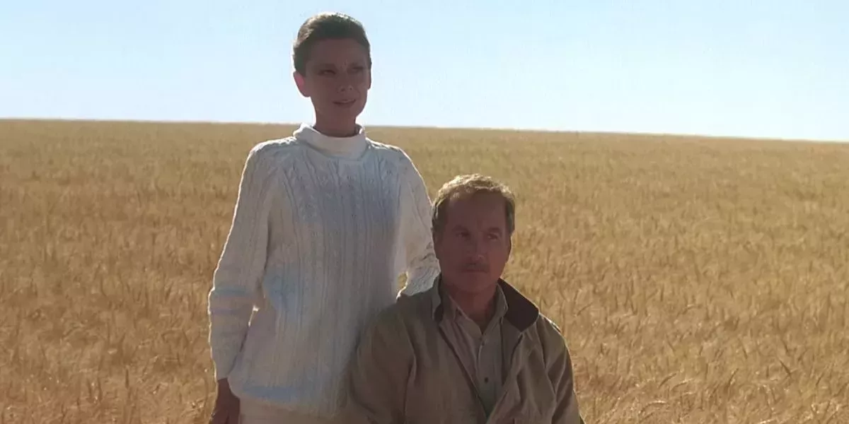 Richard Dreyfuss and Audrey Hepburn standing in a field in Always