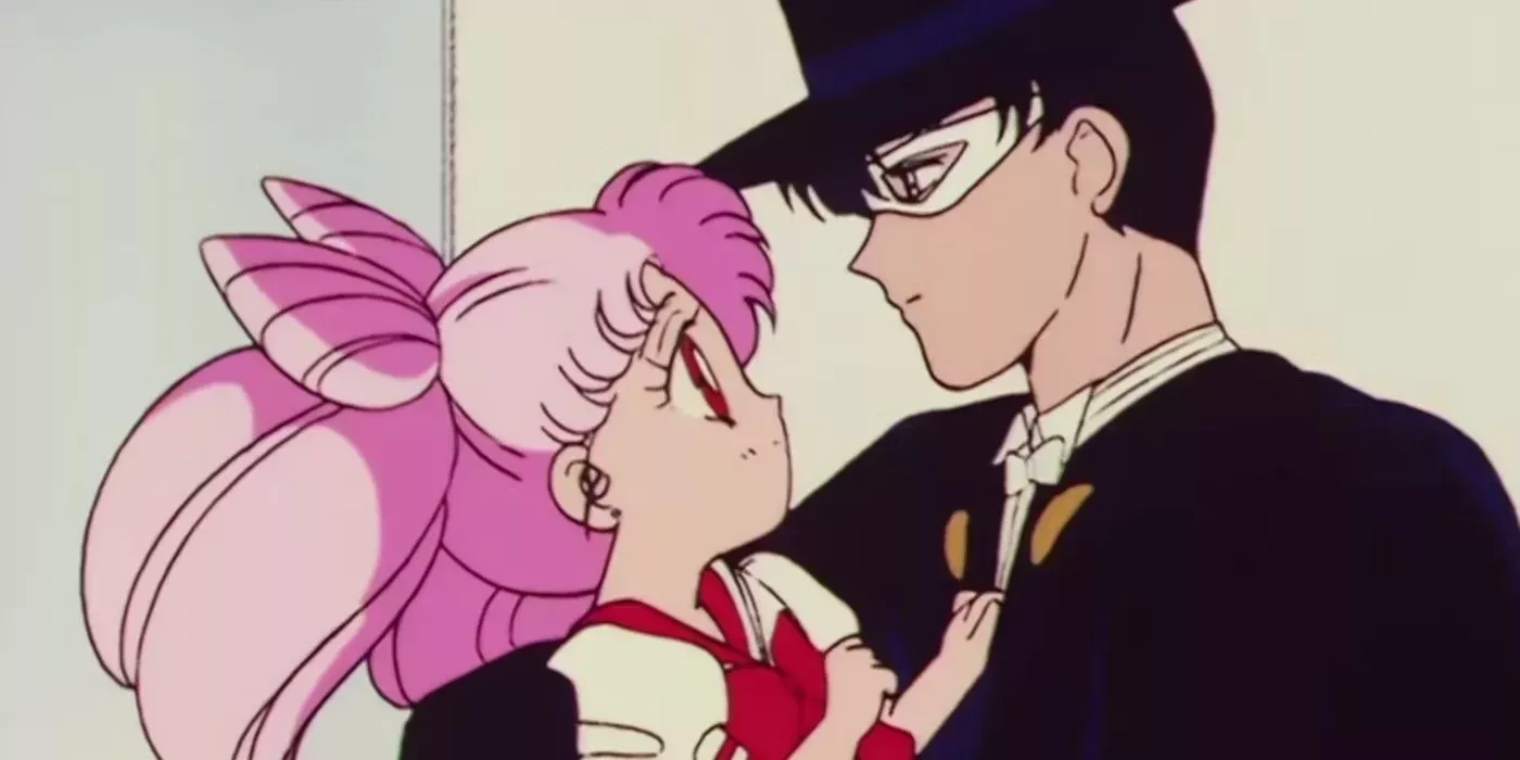 Chibiusa Mamoru looking up at Tuxedo Mask in the original Sailor Moon R