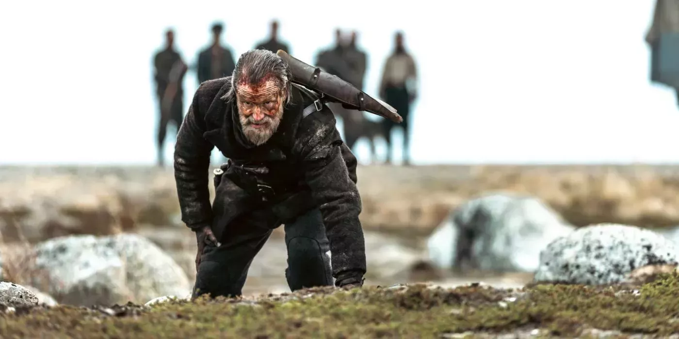 Sisu's Korpi crawls through a field with a pickax on his back