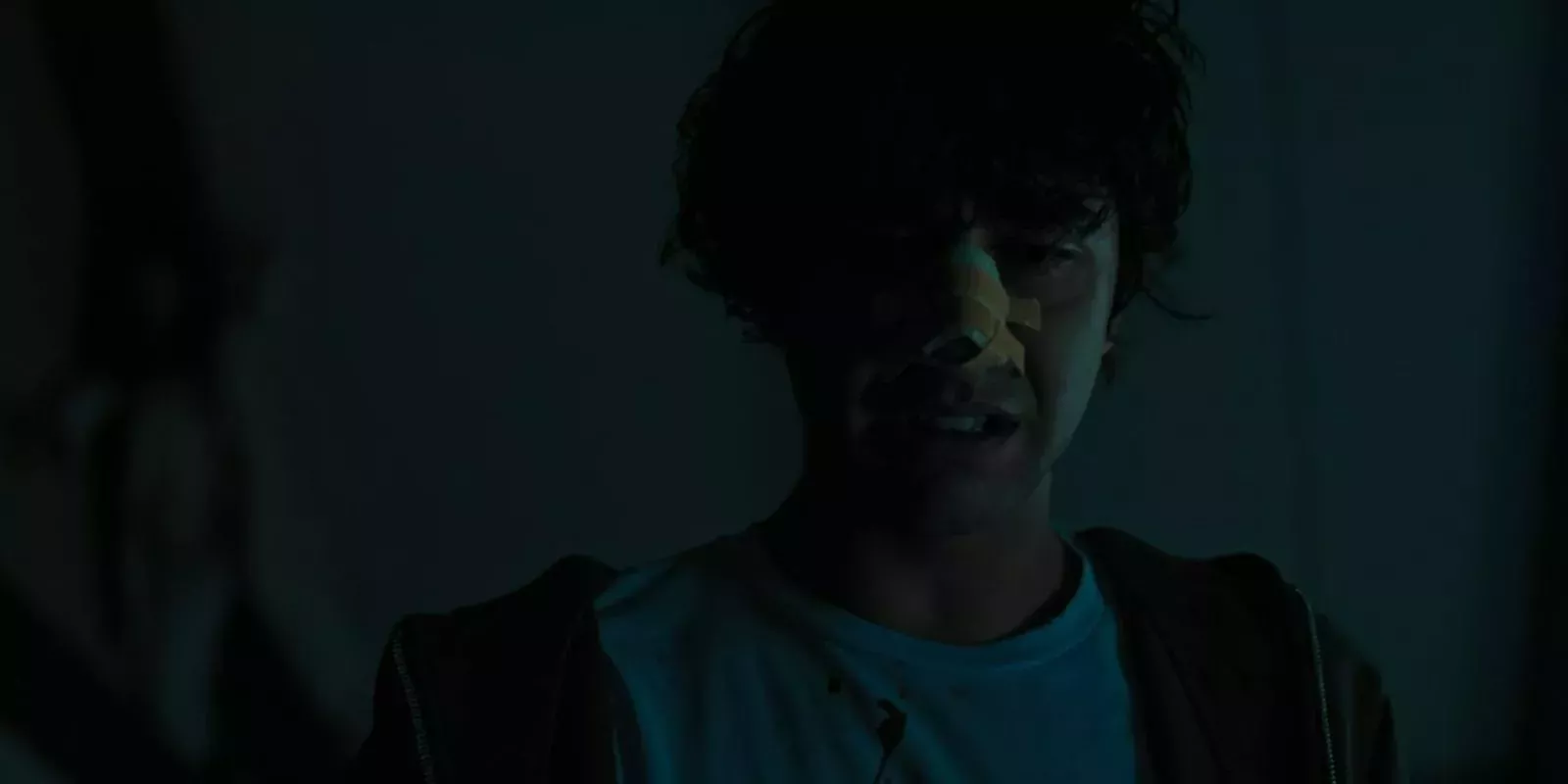 Peter Graham looks down in horror and his mother Annie looms on the ceiling, blurry in the background in Hereditary