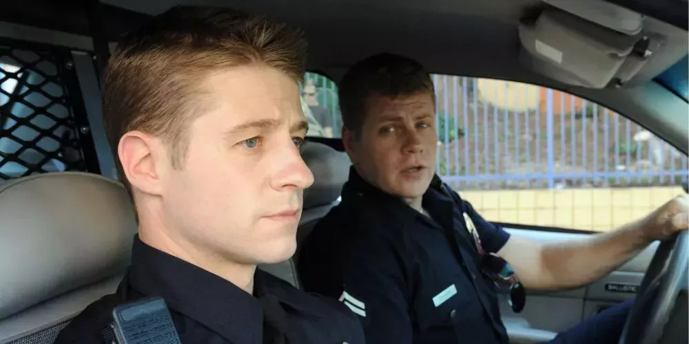 John Cooper instructs his partner Ben Sherman as they sit in their police car in Southland