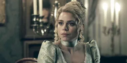 Lily wears a green dress and a ribbon in Penny Dreadful.