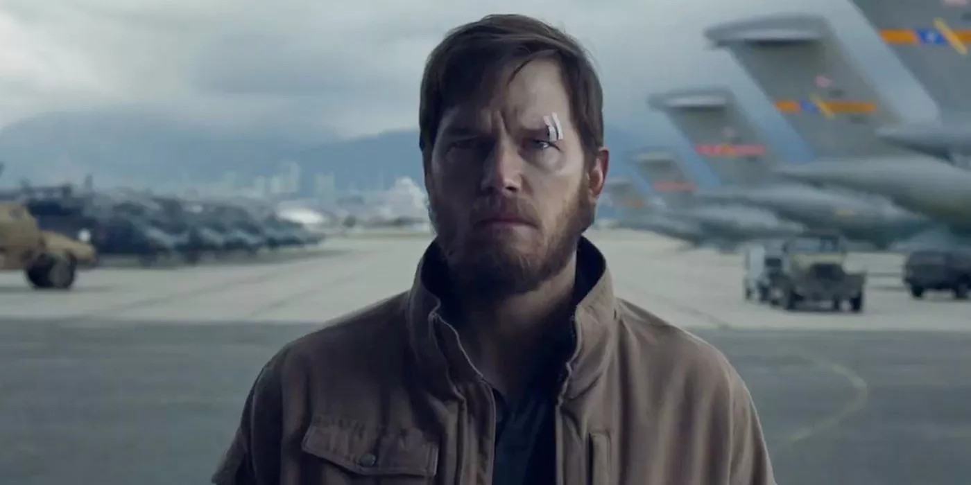 Chris Pratt standing in an airfield looking worried with bandages on his eyebrow in The Terminal List.