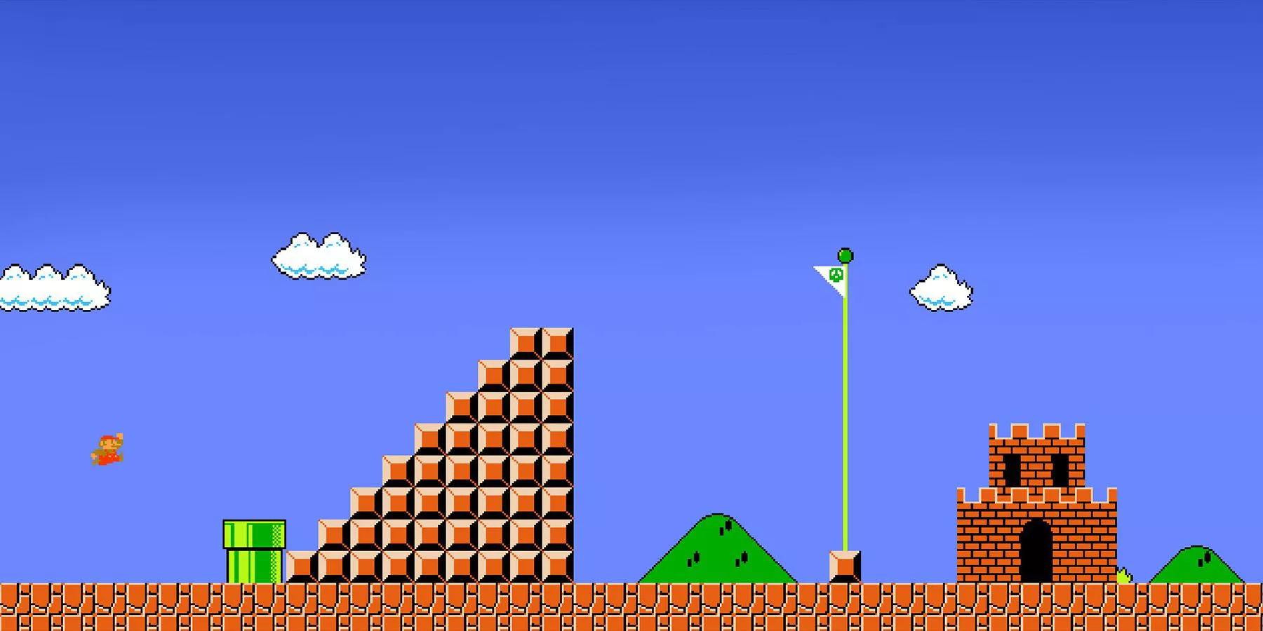 Mario approaches the flag at the end of World 1-1 in Super Mario Bros.