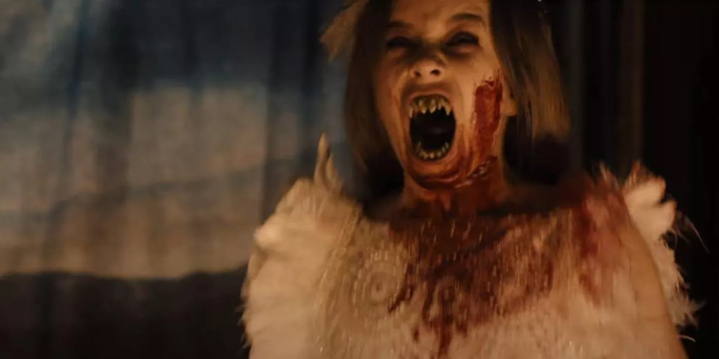 Abigail vampire screaming while drenched in blood.