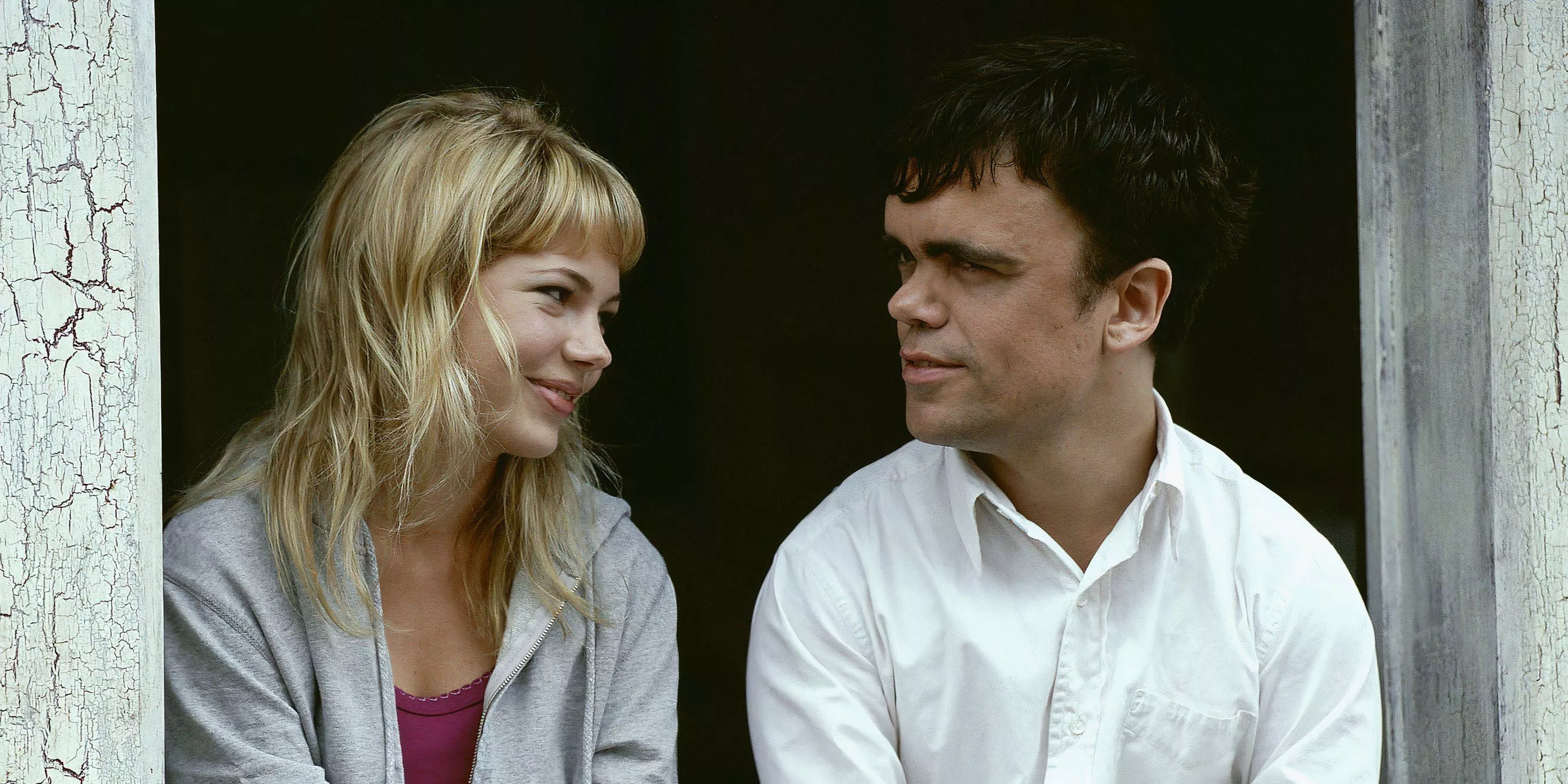 Michelle Williams and Peter Dinklage smile at each other in The Station Agent
