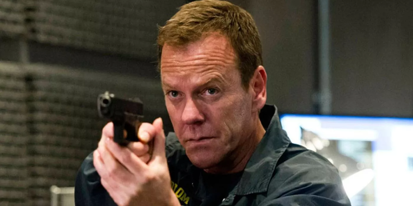 Jack Bauer (Kiefer Sutherland) aims a gun at an off-camera suspect in 24