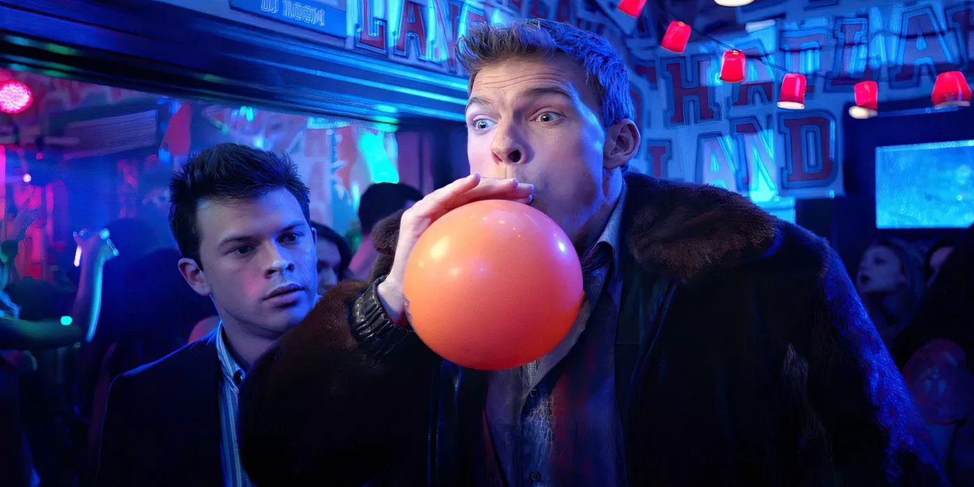 Thad Castle (Alan Ritchson) is blowing up a balloon at a party in Blue Mountain State