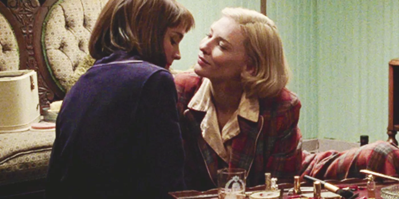 Carol smiles at Therese while they sit together in Carol (2015). 
