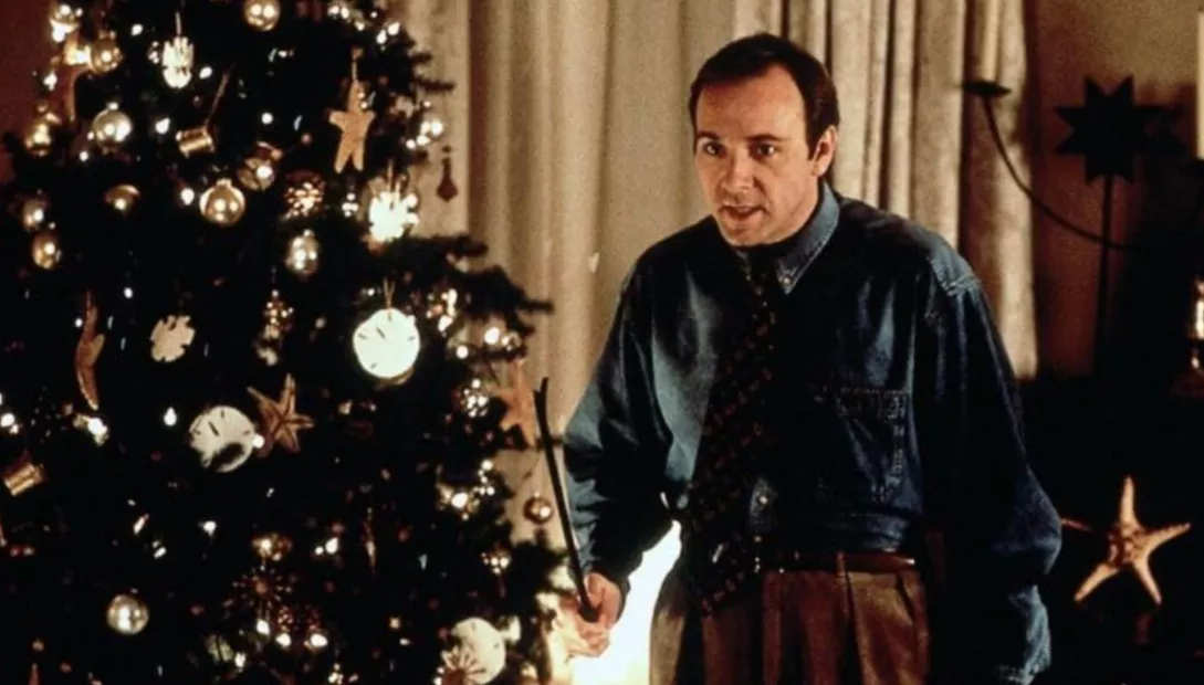 Kevin Spacey holds a crowbar by a Christmas Tree in The Ref.