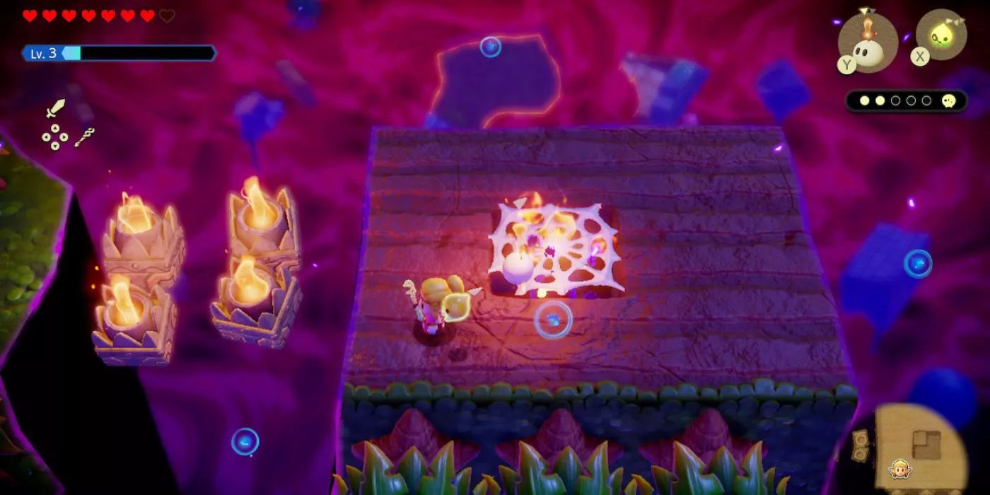 Princess Zelda uses an Ignizol to burn a spider web trapping an orb containing Tri's friends in the Stilled Blossu’s House in The Legend of Zelda Echoes of Wisdom