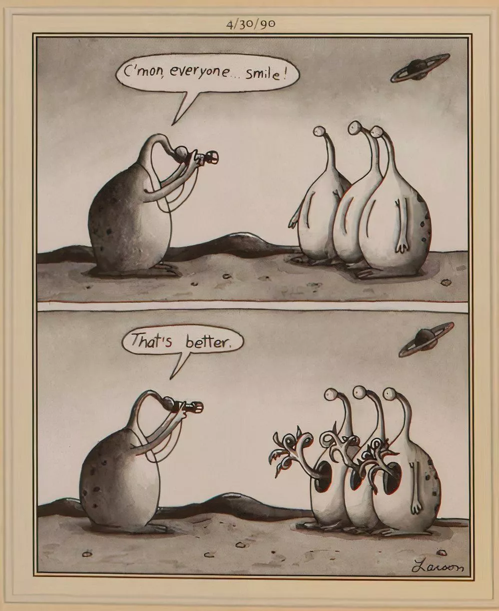 Aliens pose for a picture and smile in an unusual way.