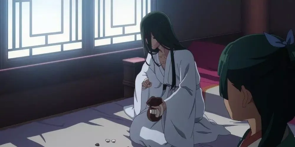 Fengxian playing Go while Maomao watches in The Apothecary Diaries.